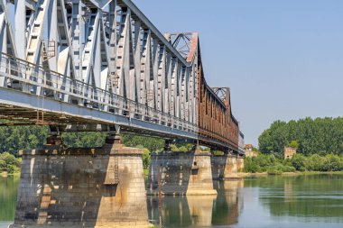 Old Rusty Metal Railway Bridge With Stone Columns Over River Sava