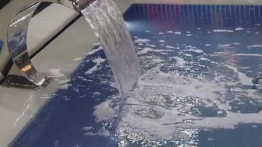 Water Flow From Waterfall Device in Modern Spa Pool