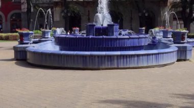 Subotica, Serbia - August 01, 2022: Blue Tiles Fountain Landmark and Historic City Hall Building Hot Summer Day Tilt up.