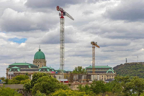 Tall Cranes at Buda Castle Palace Construction Site Cloudy Weather
