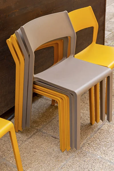 Stack of Plastic Chairs at Outdoor Terrace Patio Tiles