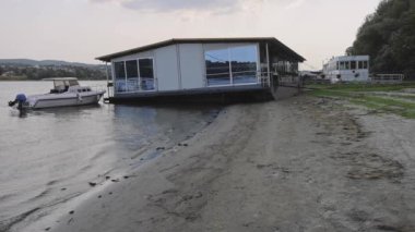 Novi Sad, Serbia - August 19, 2022: Pontoon Restaurant Low Water Tide River Danube Drought Problems.