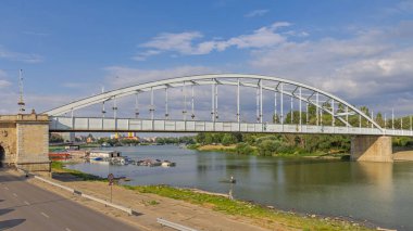 Szeged, Hungary - July 30, 2022: Downtown Bridge Belvarosi Over Tisza River at Hot Sunny Summer Day.
