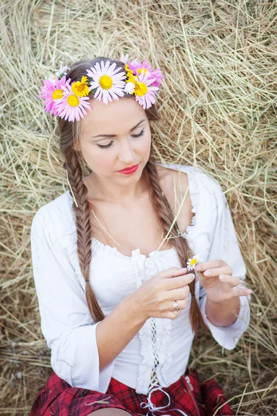 Girl with flower wreath outdoors — Stock Photo, Image