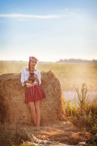 Girl with flower wreath outdoors — Stock Photo, Image