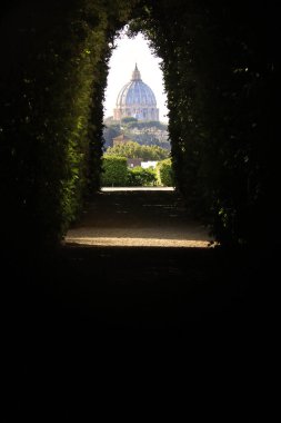 An amazing view of St. Peter's Dome through the Knights of Malta keyhole on the eventide hill in Rome. clipart