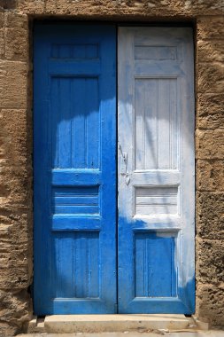 A white and blue closed door in the Lebanese town of Batroun.