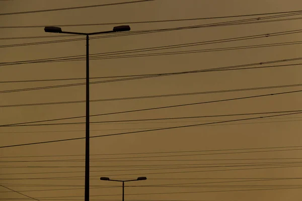 Background Powerlines Street Lamps Yellow Sky — Stockfoto