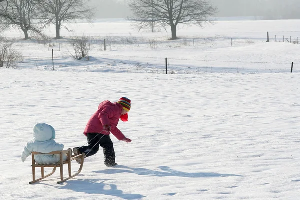 Sisters on snow — Stock Photo, Image