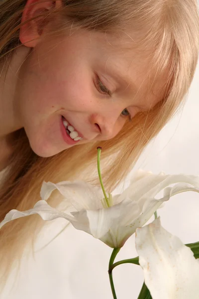 Girl and lilies — Stock Photo, Image