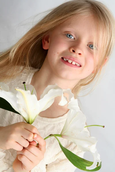 Girl and lilies — Stock Photo, Image