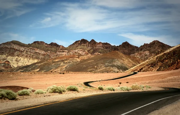 Estrada solitária através das montanhas — Fotografia de Stock
