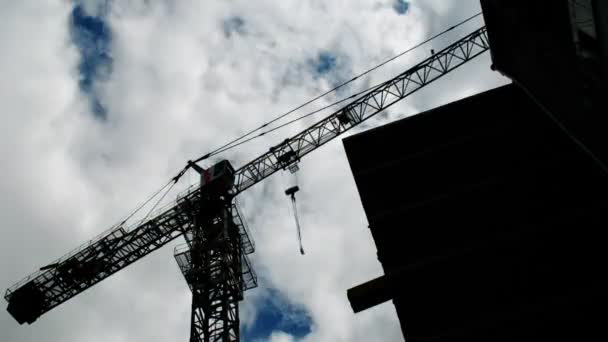 Construction crane working against the blue sky and clouds — Stock Video