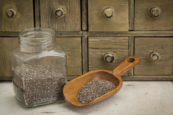 Jar and scoop of chia seeds — Stock Photo, Image