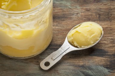 ghee in jar and spoon clipart