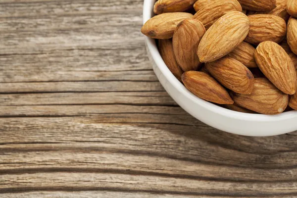 Almond nuts in a bowl — Stock Photo, Image