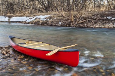 red canoe on a river clipart