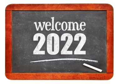 Hoş geldiniz 2022 - Beyaz üzerine izole edilmiş eski bir tahta üzerine yeni yıl konsepti