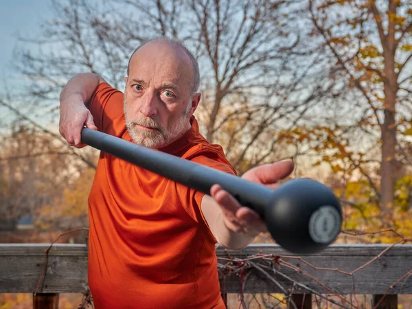 Homem Sênior Está Exercitando Com Uma Maça Aço Seu Quintal — Fotografia de Stock