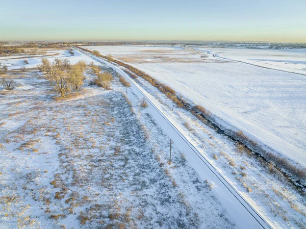 Winter Sunset Colorado Plains Railroad Tracks Power Line Irrigation Ditch — стоковое фото