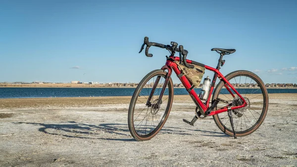 lightweight gravel or touring bike with a carbon frame on a lake shore - Boyd Lake State Park, Colorado
