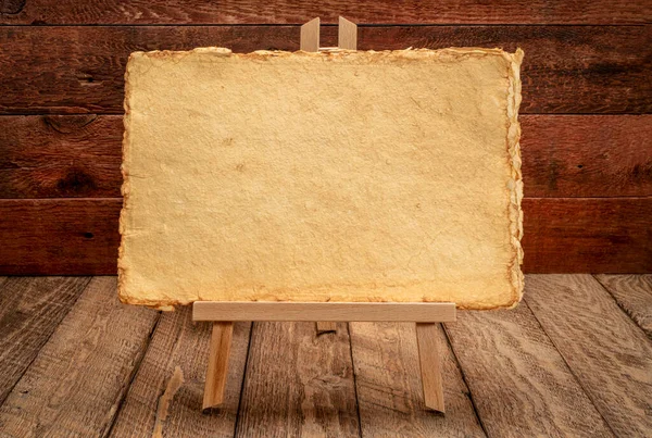 Small Easel Sign Handmade Yellow Paper Rustic Weathered Wood Background — Stock Photo, Image