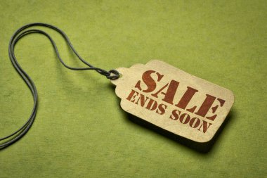 sale ends soon - a paper price tag against green background, marketing and shopping concept