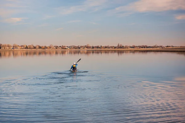 Man Long Racing Kayak Wing Paddle Paddling Away Calm Lake — стокове фото