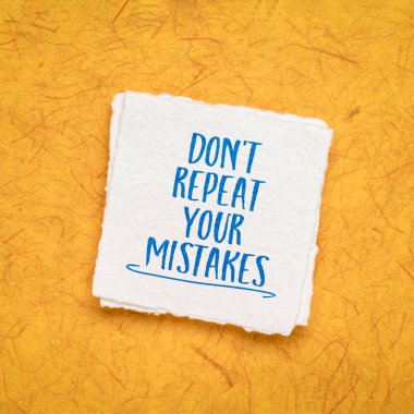 do not repeat your mistakes inspirational advice or reminder - handwriting on a handmade paper, learning and personal development concept