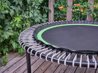 detail of mini trampoline for fitness exercising and rebounding in a backyard patio