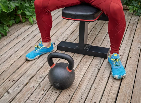 Male Wearing Compression Tights Exercising Heavy Iron Kettlebell Backyard Wooden — Stock Photo, Image