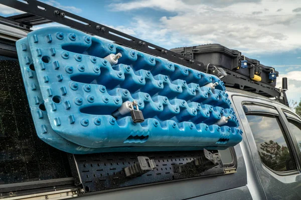 recovery traction ladders mounted on side racks of a truck, used to enhance tire traction in mud, snow or sand emergency conditions