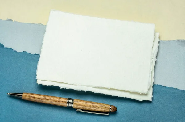 白い紙の小さなシートハディは 抽象的な風景に対してスタイリッシュなペンで紙をドラッグ — ストック写真