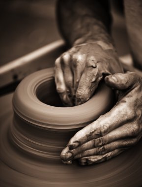 Hands working on pottery wheel clipart