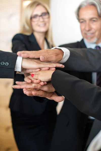 Teamwork - business people with joint hands in the office — Stock Photo, Image