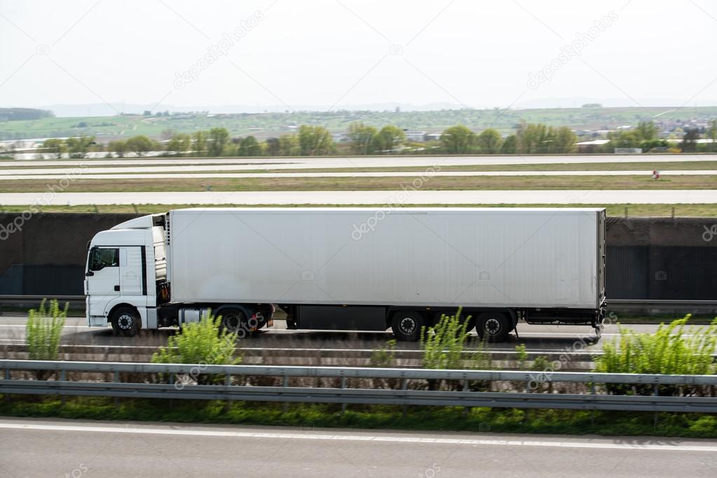 White truck moving on a highway