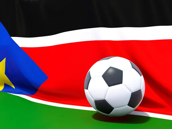 Bandera del sur de Sudán con el fútbol en frente de ella — Foto de Stock