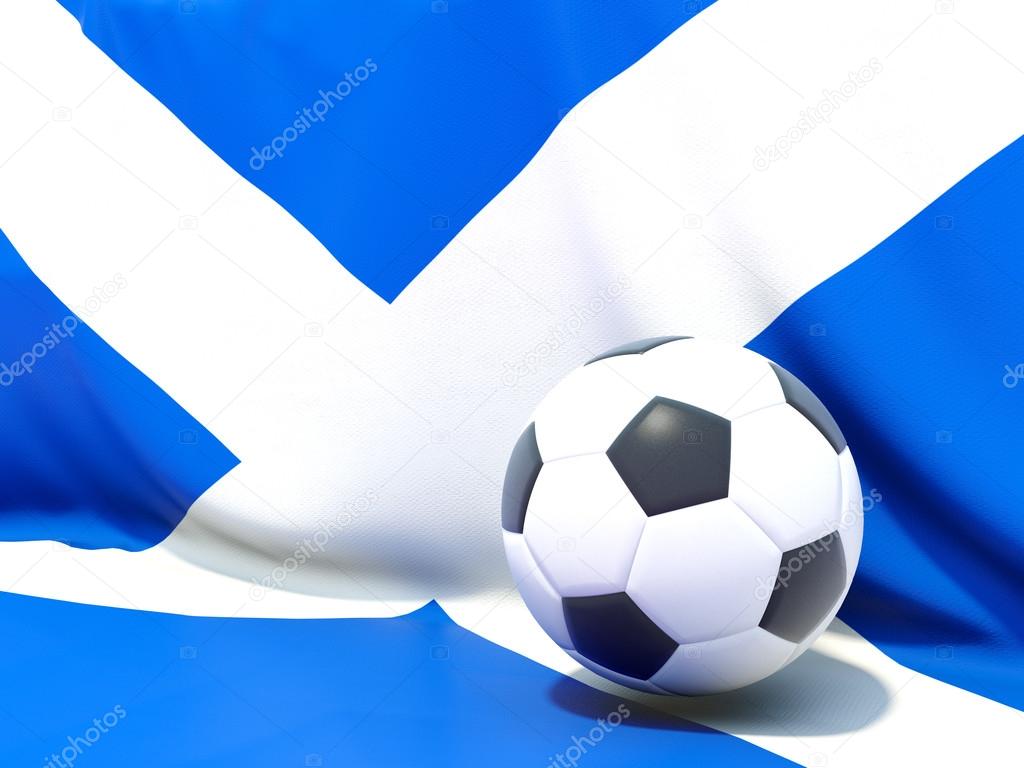 Flag of scotland with football in front of it