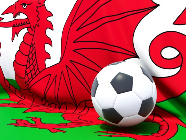 Flagga wales med fotboll framför den — Stockfoto