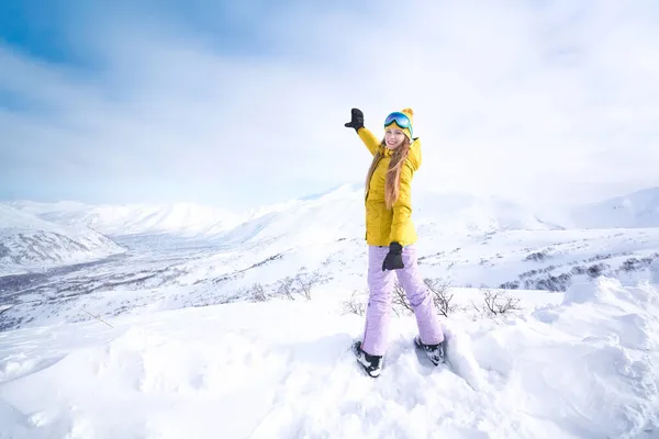 Wesoła Dziewczyna Snowboardzistka Żółtej Kurtce Przed Śnieżnymi Górami Błękitnym Niebem — Zdjęcie stockowe