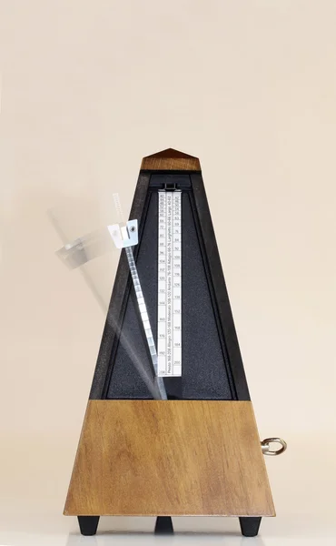 Metronome with Blurred Moving Arm Brown Background — Stock Photo, Image