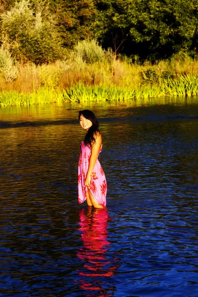 Χαμογελώντας ανατολίτικα νεαρή γυναίκα ποταμού φόρεμα σε εξωτερικούς χώρους — Φωτογραφία Αρχείου