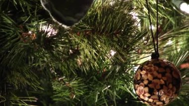 Tight Shot Of Christmas Tree Branches With Short Pan To Floral Ornament