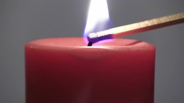 Closeup Shot Red Candle Being Lit Wooden Match Gray Background — 图库视频影像