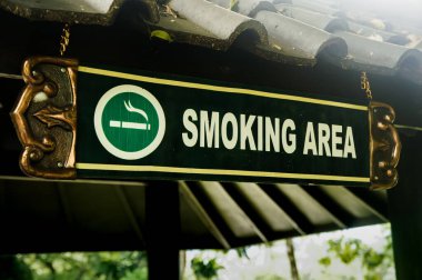Halka açık bir alanda sigara içme alanı tabelası yerleştirilmiş.