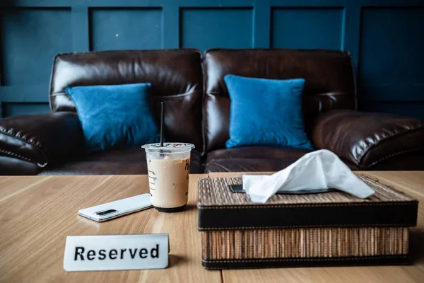 Cup Iced Coffee Reserved Table Restaurant Leather Sofa Background — Stock fotografie