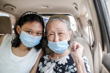 Smiling and Happy Asian Teen Girl and Grandma in Car