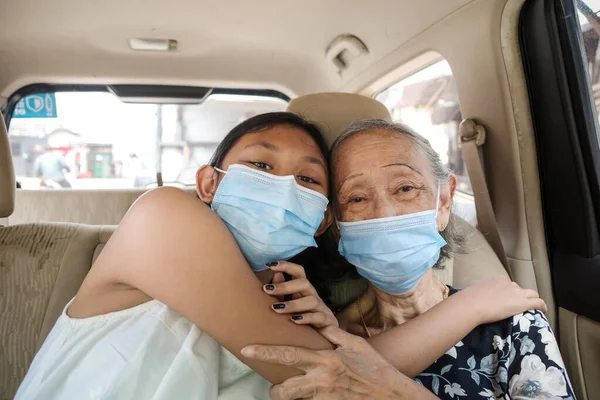 Asian Teen Girl Hugging Grandmother Love Car ロイヤリティフリーのストック画像