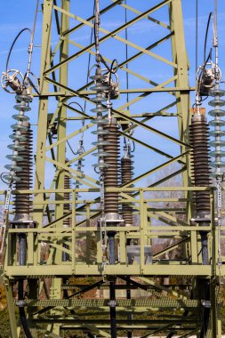 Dağıtım güç istasyonundan çarpıcı bulutlu arkaplanlı elektrik direkleri akımı iletiyor