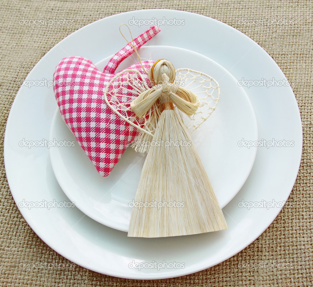 Romantic serving of festive table with a handmade decoration ang